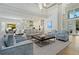 Spacious living area featuring high ceilings, modern decor, comfortable seating, and views into the open kitchen at 5103 Windward Ave, Sarasota, FL 34242