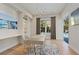 Bright office featuring custom built-ins, a sleek desk, and large windows overlooking the pool at 5103 Windward Ave, Sarasota, FL 34242