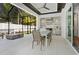 Covered outdoor kitchen and dining area with fire pit and tile flooring at 5103 Windward Ave, Sarasota, FL 34242