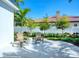 Cozy patio area featuring a stone-tile floor, manicured shrubs, and a white-picket fence at 5103 Windward Ave, Sarasota, FL 34242