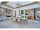 An open-air patio features an outdoor kitchen, dining area, and access to the main house through sliding glass doors at 5103 Windward Ave, Sarasota, FL 34242