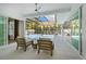 Outdoor space featuring a screened-in pool and lounging area, perfect for relaxation at 5103 Windward Ave, Sarasota, FL 34242