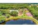 Aerial view of a pool, tennis courts, playground, and lush landscaping in the community at 515 Honeyflower Loop, Bradenton, FL 34212