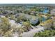 Scenic aerial view of a multi-Gathering building with lush landscaping, parking, and a tranquil lake in the background at 5160 Northridge Rd # 302, Sarasota, FL 34238