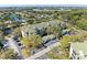 Aerial view shows parking and condo exterior, surrounded by lush trees and landscaping near a pond at 5160 Northridge Rd # 302, Sarasota, FL 34238