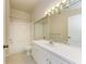 Bathroom with white vanity, updated mirror, lighting and tile flooring at 5160 Northridge Rd # 302, Sarasota, FL 34238