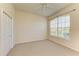 Bedroom features neutral carpet, ceiling fan and access to closet at 5160 Northridge Rd # 302, Sarasota, FL 34238