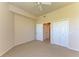 Bedroom features neutral carpet, ceiling fan and access to multiple closets at 5160 Northridge Rd # 302, Sarasota, FL 34238