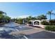 Community entrance with tropical landscaping and signage at the front gate, creating an inviting sense of arrival at 5160 Northridge Rd # 302, Sarasota, FL 34238