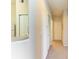 Bright hallway features neutral paint, neutral carpet and access to bedrooms and bathrooms at 5160 Northridge Rd # 302, Sarasota, FL 34238