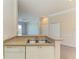 Kitchen sink and counter, flowing into the living space with white appliances at 5160 Northridge Rd # 302, Sarasota, FL 34238