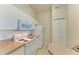 Well-lit kitchen featuring white appliances and ample cabinet space at 5160 Northridge Rd # 302, Sarasota, FL 34238