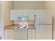 Bright kitchen with white appliances and plenty of storage at 5160 Northridge Rd # 302, Sarasota, FL 34238