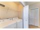 Laundry room with washer, dryer and storage shelves at 5160 Northridge Rd # 302, Sarasota, FL 34238