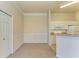 Open-concept living space with neutral carpeting, an eat-in kitchen, and a closet at 5160 Northridge Rd # 302, Sarasota, FL 34238
