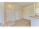 Inviting condo living room features neutral carpeting, a front door with tiled foyer, and a glimpse of the kitchen at 5160 Northridge Rd # 302, Sarasota, FL 34238