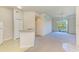 Open living room with neutral carpet, ceiling fan, and balcony access at 5160 Northridge Rd # 302, Sarasota, FL 34238