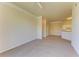 Spacious living room featuring neutral carpet and seamless flow to kitchen at 5160 Northridge Rd # 302, Sarasota, FL 34238