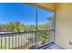 Screened patio area with railing overlooking surrounding buildings and mature trees at 5160 Northridge Rd # 302, Sarasota, FL 34238