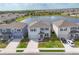 Aerial view of homes by a lake with a fountain and manicured lawns in a residential neighborhood at 5216 Adega Way, Bradenton, FL 34211