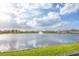 Beautiful view of the lake with a fountain, surrounded by well-maintained lawns and neighborhood houses at 5216 Adega Way, Bradenton, FL 34211