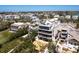 Stunning aerial view of the luxurious home highlighting the rooftop terrace and lush landscaping at 534 Beach Rd, Sarasota, FL 34242