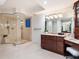 A modern bathroom featuring a glass shower and a marble countertop vanity at 534 Beach Rd, Sarasota, FL 34242