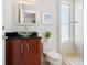 This bathroom features a modern glass vessel sink, wood cabinet and tile shower at 534 Beach Rd, Sarasota, FL 34242