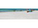 Idyllic beach scene with turquoise water, sandy shore and people enjoying the sunshine and refreshing ocean breeze at 534 Beach Rd, Sarasota, FL 34242