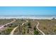 Scenic view of beach and walking path from lushly landscaped home at 534 Beach Rd, Sarasota, FL 34242