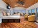 Bedroom featuring a decorative wood ceiling, a flat-screen TV, and an exterior view through multiple windows at 534 Beach Rd, Sarasota, FL 34242