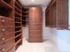 This walk-in closet has custom cabinetry, shelving and drawers for organizing clothes at 534 Beach Rd, Sarasota, FL 34242