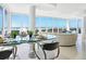 Elegant dining area with glass table, seating, and breathtaking ocean views at 534 Beach Rd, Sarasota, FL 34242