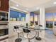 Dining room with a modern glass table and a window view of the sunset at 534 Beach Rd, Sarasota, FL 34242