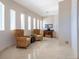 Elegant entryway with beautiful tile flooring, wicker chairs, stylish table and decor at 534 Beach Rd, Sarasota, FL 34242