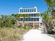 Stunning exterior of multi-story home with private beach access and balconies on each floor at 534 Beach Rd, Sarasota, FL 34242