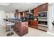 Modern kitchen with stainless steel appliances, dark wood cabinets and breakfast bar at 534 Beach Rd, Sarasota, FL 34242
