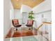 Loft with 2 swivel chairs and stylish wood and glass floors with custom railings at 534 Beach Rd, Sarasota, FL 34242