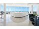 Bright living room features a modern white leather sofa with ocean views and marble floors at 534 Beach Rd, Sarasota, FL 34242