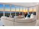 Bright living room features a modern white leather sofa with floor to ceiling windows offering gorgeous ocean views at 534 Beach Rd, Sarasota, FL 34242