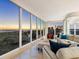 Spacious living room with walls of windows showcasing sunset views at 534 Beach Rd, Sarasota, FL 34242