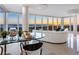 Living room with a modern glass table and an ocean sunset view at 534 Beach Rd, Sarasota, FL 34242