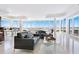 Elegant living room with marble floors, floor to ceiling windows, and ocean views at 534 Beach Rd, Sarasota, FL 34242