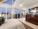 Main bedroom with balcony access, a large dresser, and a ceiling fan at 534 Beach Rd, Sarasota, FL 34242