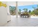 Inviting outdoor dining area with tile flooring, BBQ and comfortable seating with stunning views of the lush landscaping at 534 Beach Rd, Sarasota, FL 34242