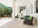 Cozy outdoor patio with stylish wicker furniture and views of lush landscaping, perfect for relaxing and enjoying the serene atmosphere at 534 Beach Rd, Sarasota, FL 34242