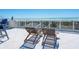 Rooftop deck with lounge chairs and glass railings showcasing beautiful ocean views, perfect for relaxation and enjoying coastal scenery at 534 Beach Rd, Sarasota, FL 34242