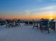 A rooftop deck with a view of the ocean at sunset at 534 Beach Rd, Sarasota, FL 34242