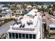 Stunning rooftop deck featuring stylish outdoor seating and panoramic views of the surrounding neighborhood and beautiful landscaping at 534 Beach Rd, Sarasota, FL 34242