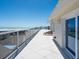 Expansive rooftop terrace features white tile, glass railings, and beach views, ideal for outdoor relaxation and entertainment at 534 Beach Rd, Sarasota, FL 34242